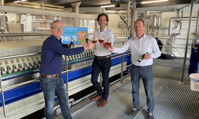 Drie mannen waaronder Jan-Paul Rutten van Gulpener proosten op de verkiezing van biologisch product van het jaar voor Sterk Rogge Tripel